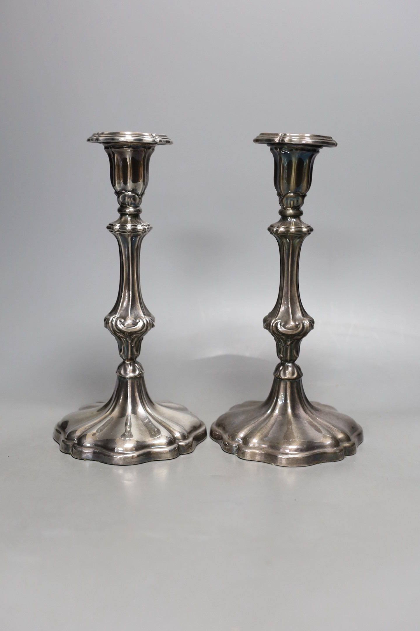 A pair of Rococo-style plated candlesticks - 24cm tall